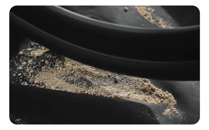 Coarse sand worn against the shell surface under controlled pressure
